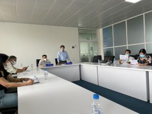 A group of people in a meeting roomDescription automatically generated